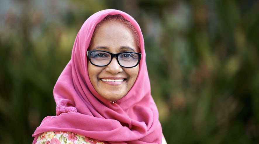 Smiling senior woman wearing a pink hijab