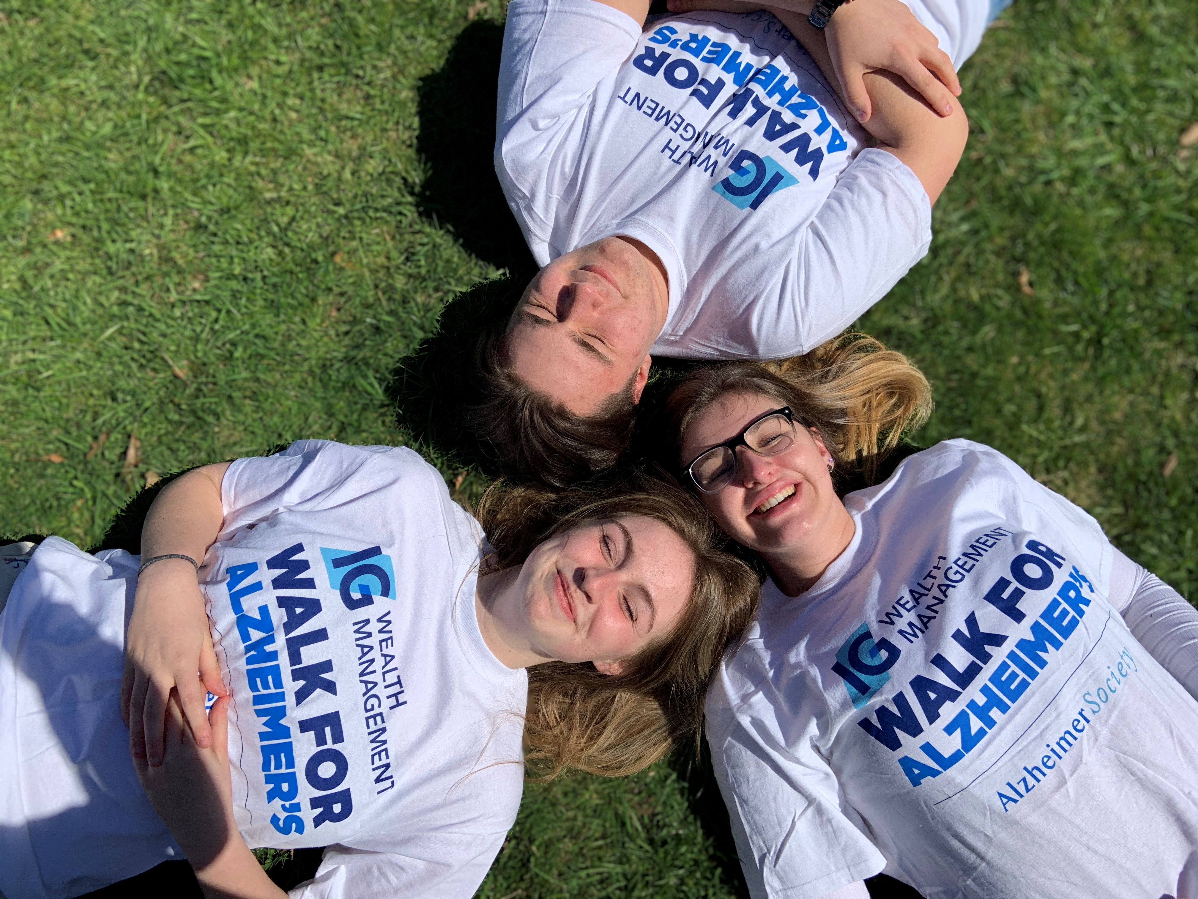 Friends lying down in the grass together at the IG Wealth Management Walk  for Alzheimer's.