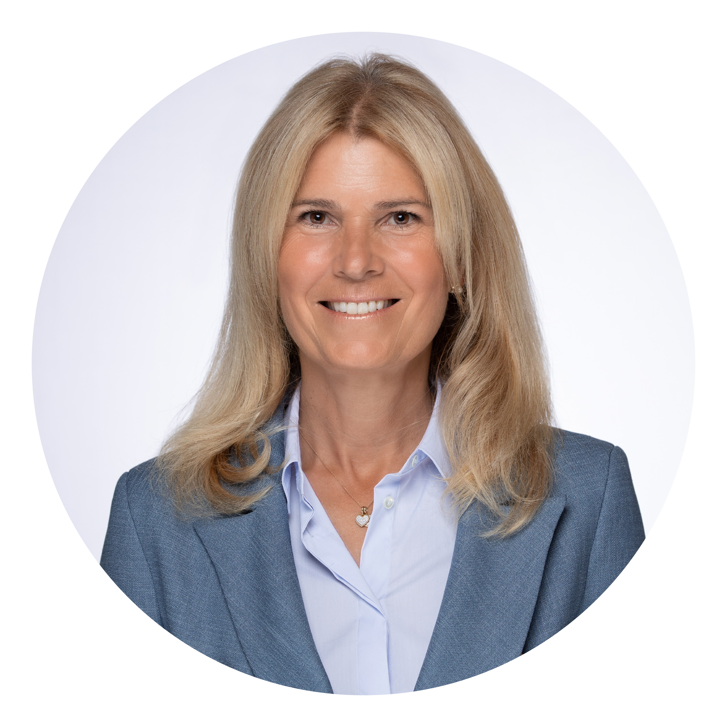 A midlife woman with shoulder length blonde hair in a blue blazer