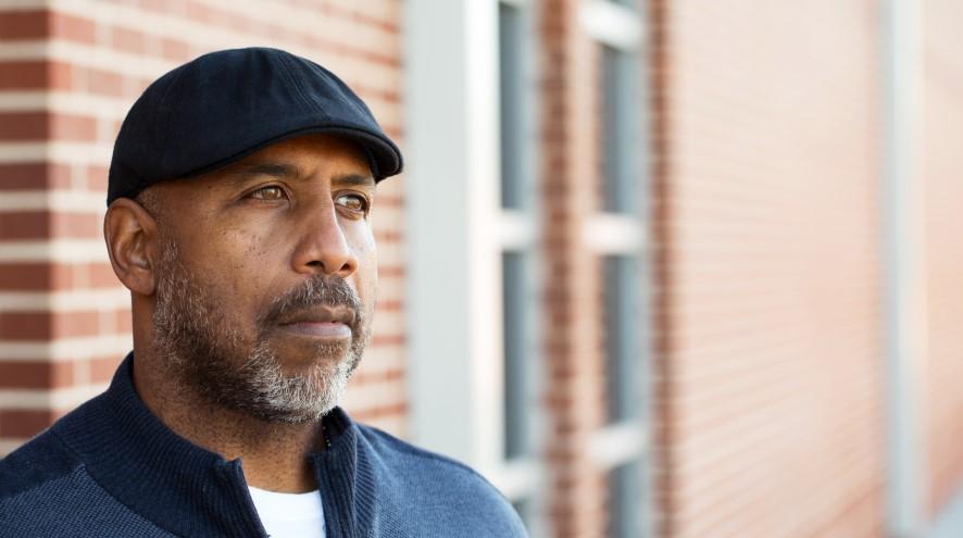 A middle-aged man in deep thought, looking concerned.