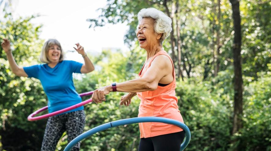 Two women exercising in the park.