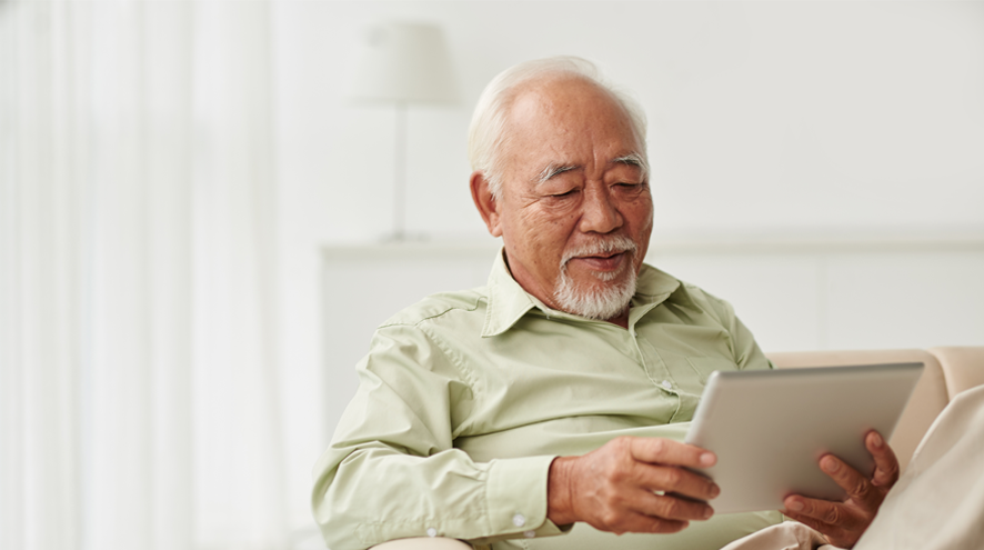 Older man looking at a tablet computer