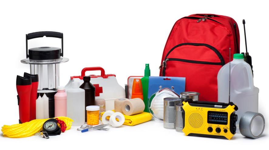 A lantern, candles, small radio, water bottle, first aid kit and other emergency prep items