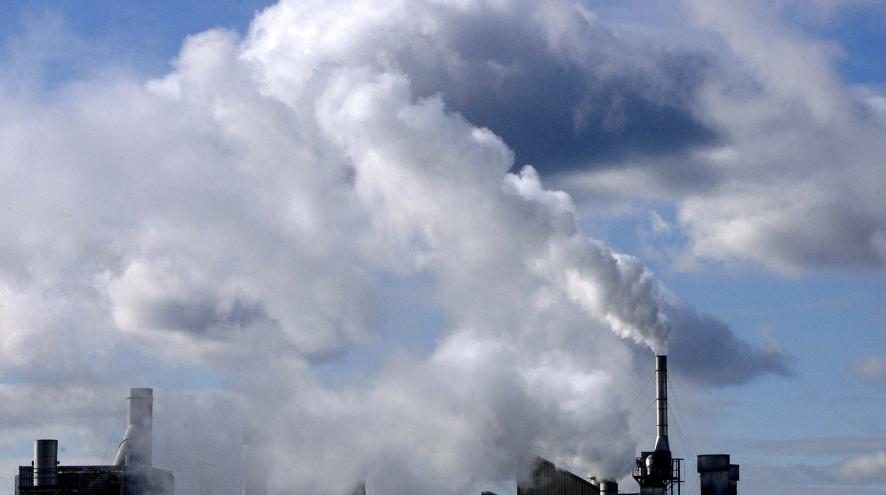 Air pollution billows out of a factory smokestack