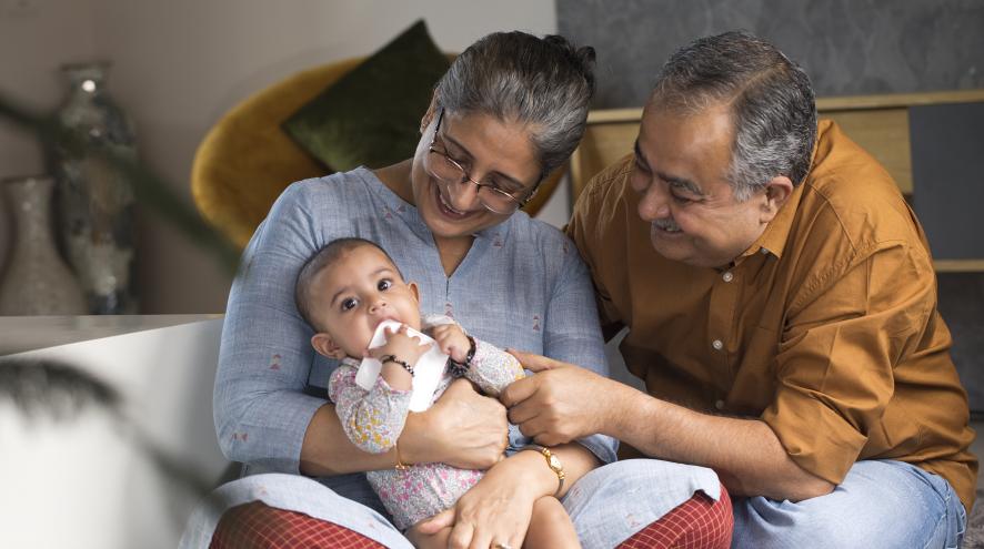 Two older people with a small grandchild