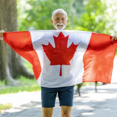 Senior man holding the Canadian flag