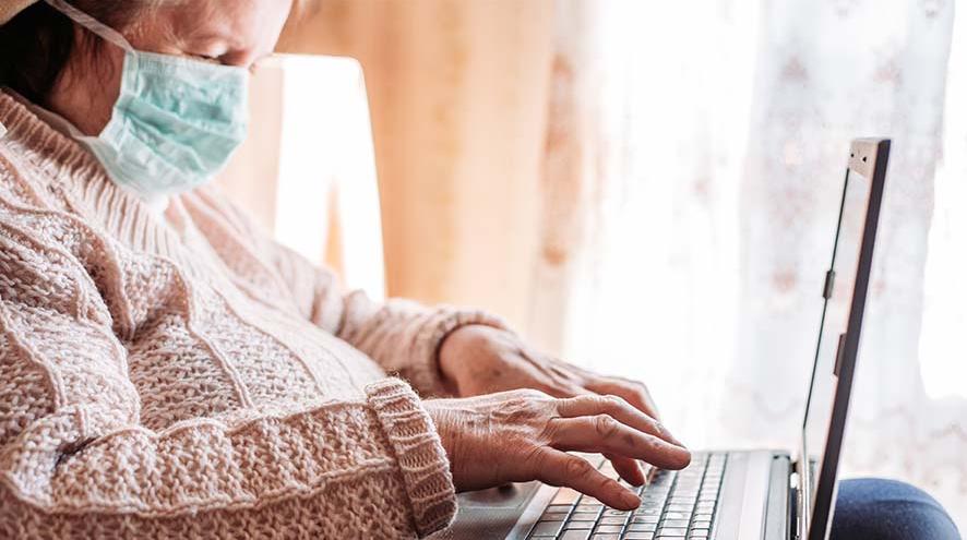 A woman typing on a laptop 