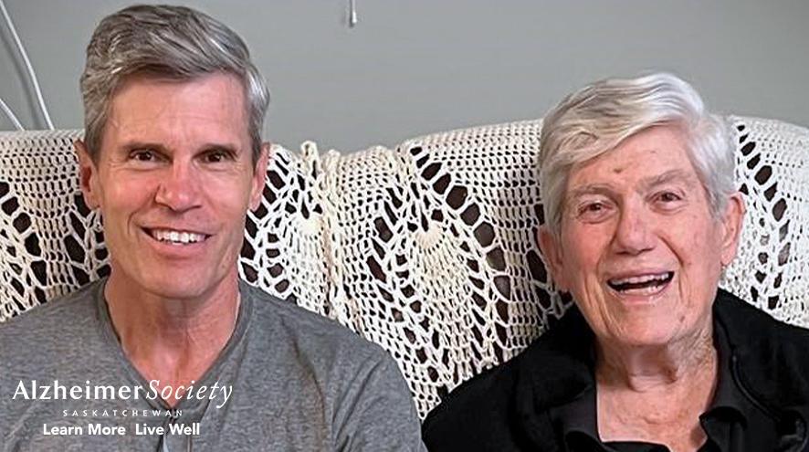 Dr. Brent Chappell sitting on a couch with his father. Both are smiling.