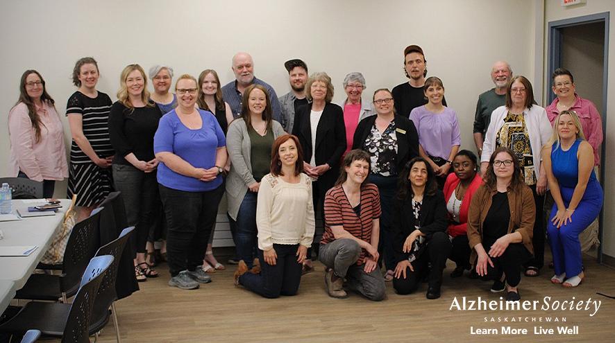 Members from the Saskatchewan Population Health and Evaluation Research Unit and collaborating organizations involved in the Dementia Supports in Rural Saskatchewan project gathered in three rows, smiling for the photo.
