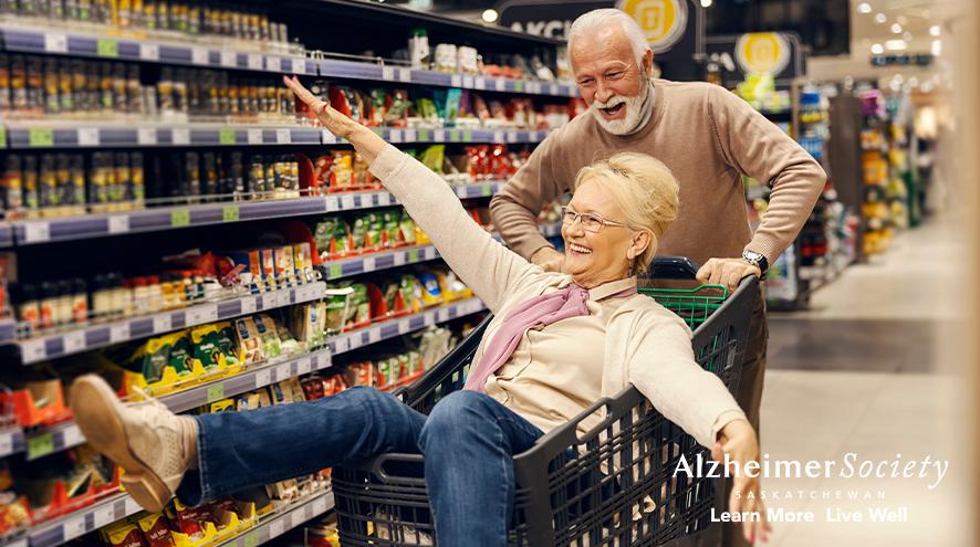 A funny old couple is driving in shopping cart at the supermarket