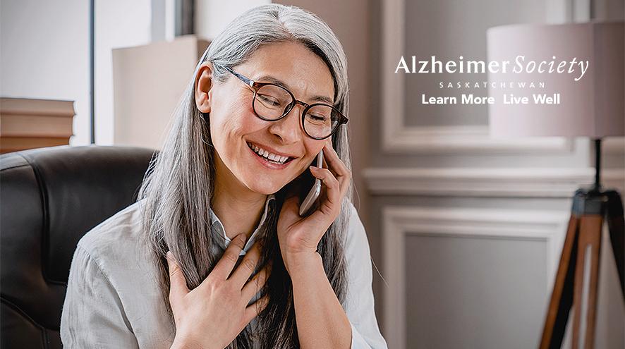 A woman who is talking on the phone. She is smiling and looks relieved.