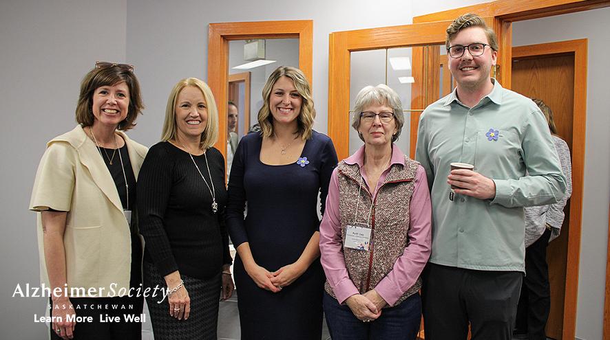 Alzheimer Society Staff and Board Members standing together, smiling, in our Provincial Office.