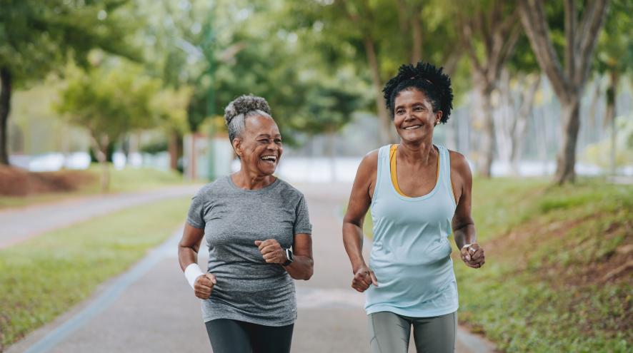 two women exercising in park
