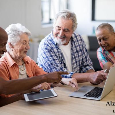 A group of people looking at laptops at the library
