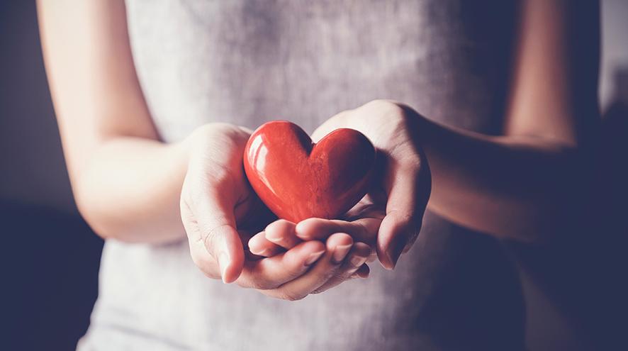 Woman holding a heart figurine.