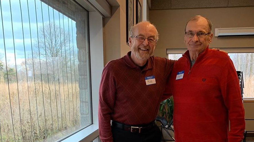 Two males smiling at the camera