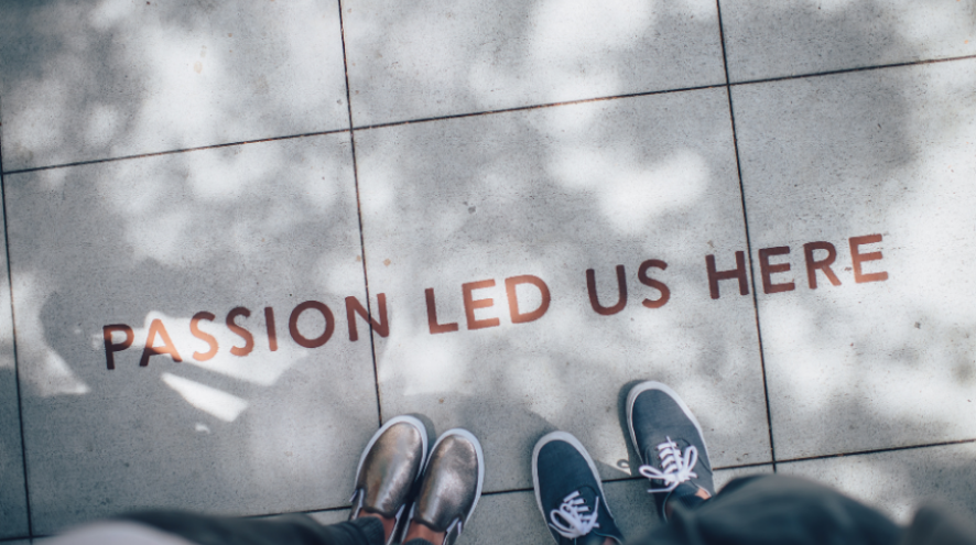 Image of shoes on concrete with the words Passion Led Us Here