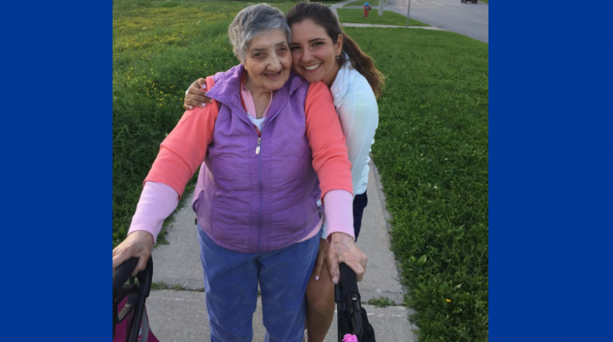 Gioulizar Smoian, who lives with dementia, standing with her walker and her granddaughter Selena Costabile hugging on a sidewalk
