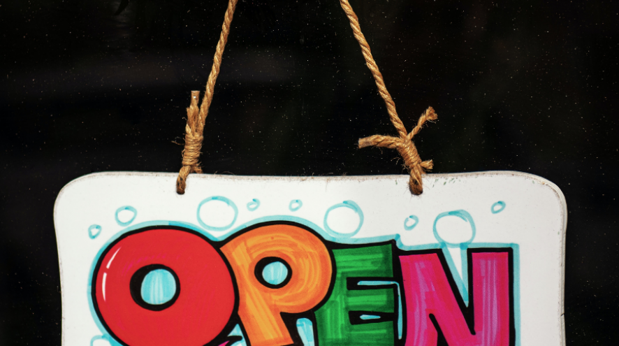 Image of a hand painted open sign in bubble letters on white background with blue bubbles and twine holding it up