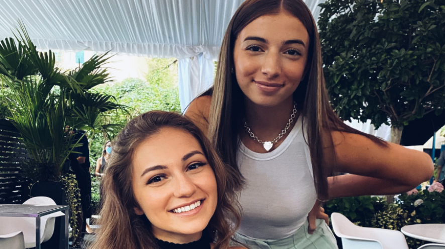 Picture of Stacey and Marianna Speranza, founders of The Business Casual, in a covered room with plants in the backgroun