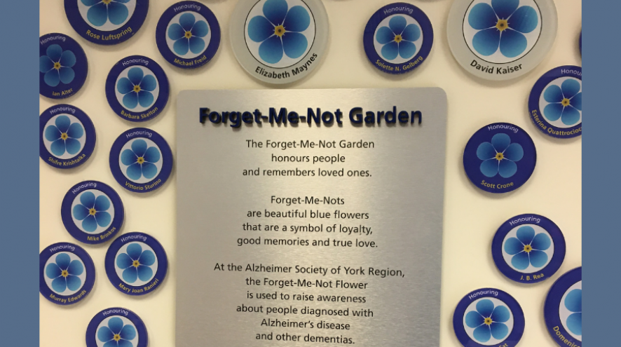 Forget-Me-Not Garden with a description of what it is and plastic flowers of various sizes surrounding it.