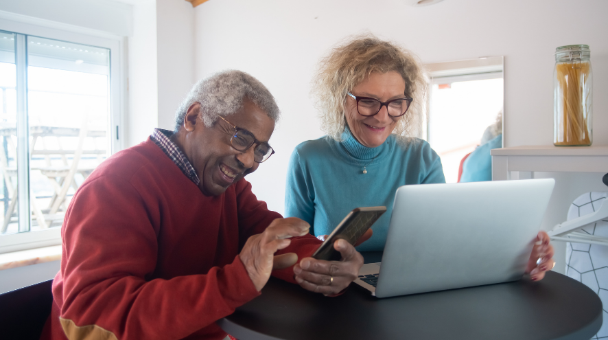 Senior couple in front of laptop