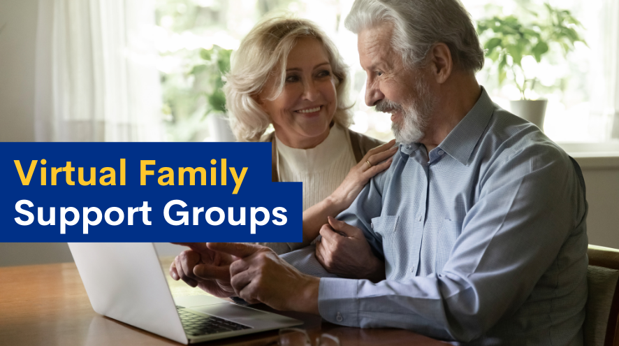 Senior couple smiling in front of computer