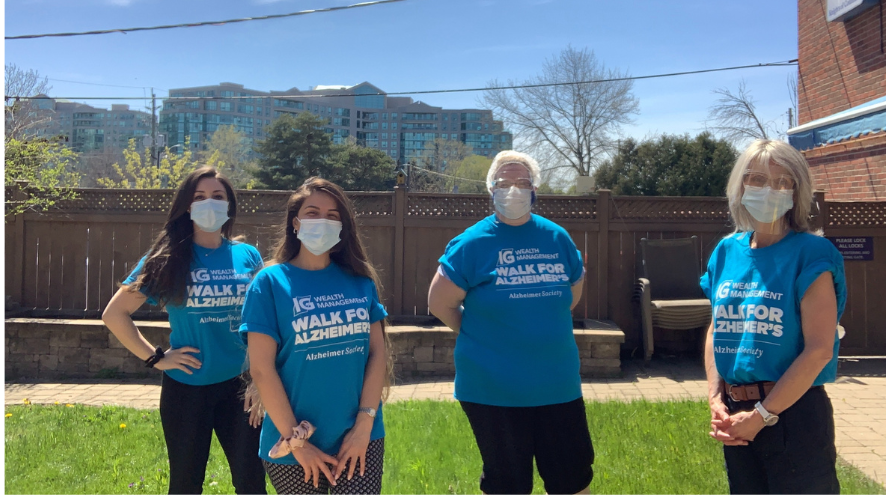 Four people wearing PPE and IG Wealth Management Walk for Alzheimer's T-shirts in the Thornhill garden