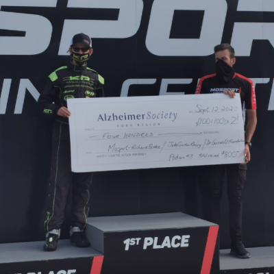 Jake Cowden holding a giant Alzheimer Society of York Region cheque after his recent go-kart win