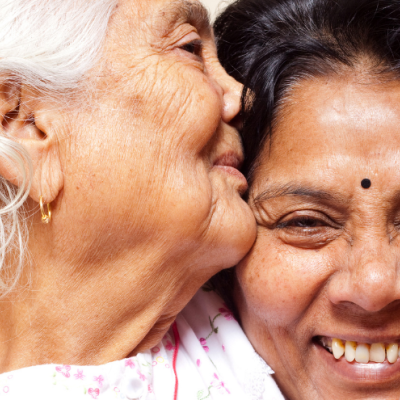 Senior mother kisses daughter's head